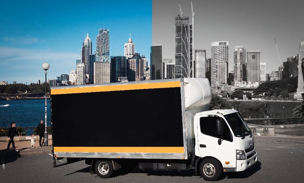Hartmann removalist truck parked against the Sydney CBD skyline ready for an office relocation